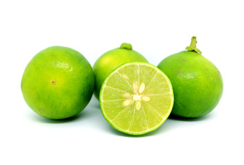 One cross section fresh limes with the whole fruits on white background	