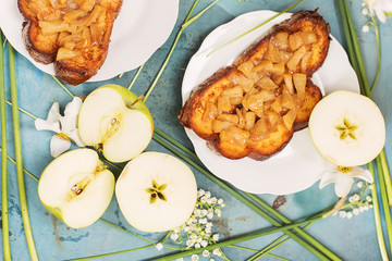 Group of sandwiches with apples and white flowers on table