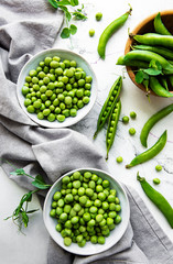 Green peas in white bowls