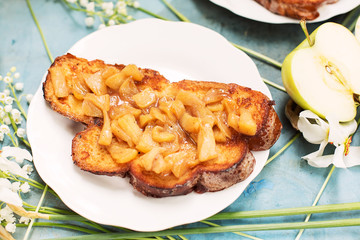 Sandwich with slices of apples on blue table