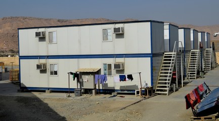Fototapeta na wymiar Portacabin, porta cabin, temporary labours camp , Mobile building in industrial site or office container Portable house and office cabins. Labor Camp. Porta cabin. small temporary houses
