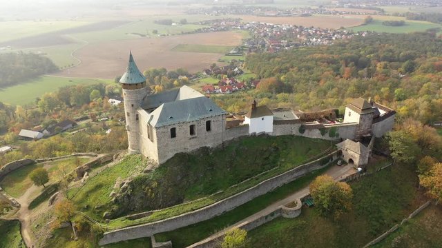 Picturesque autumn landscape with imposing historic Kuneticka Hora Castle on hilltop above Czech village of Raby, Pardubice Region