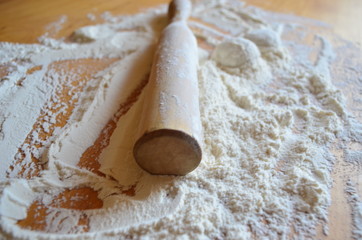 Rolling pin for rolling dough in flour on the table.