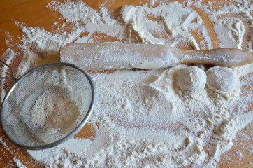 Rolling pin for rolling dough in flour on the table.