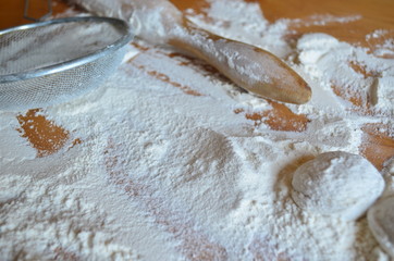 Rolling pin for rolling dough in flour on the table.