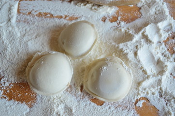 making homemade dumplings with your hands. The table is in flour.