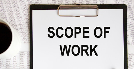 Scope of work. inscription on a white business card against the background of financial charts of a pencil and money. BUSINESS CONEPT