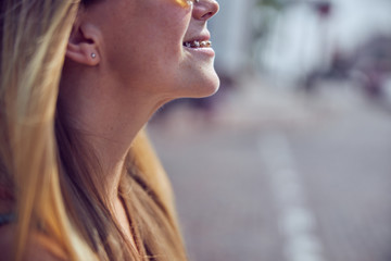 Close up cropped head shot of beautiful red-haired girl with braces