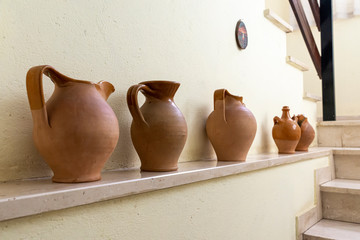 Fototapeta na wymiar ancient terracotta pot and wooden nestoli