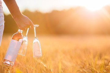 Rose wine and two glasses in male hands