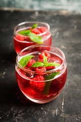 Raspberry and mint cocktail in glass on the rustic background. Selective focus. Shallow depth of field.