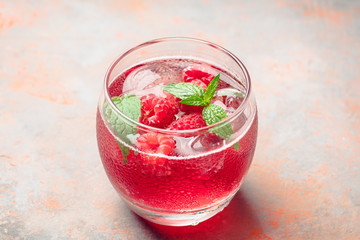 Raspberry and mint cocktail in glass on the rustic background. Selective focus. Shallow depth of field.