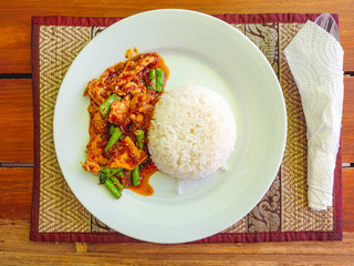 Thai Food one dish meal or Street food from Stir-fried pork with chili paste for lunch or dinner on wooden floor.