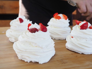 the chef decorates the dessert with fresh raspberries and strawberries. Anna Pavlovna's dessert