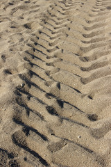 Fototapeta na wymiar tire tracks on the sand