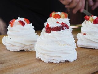 the chef decorates the dessert with fresh raspberries and strawberries. Anna Pavlovna's dessert