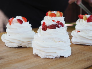 the chef decorates the dessert with fresh raspberries and strawberries. Anna Pavlovna's dessert