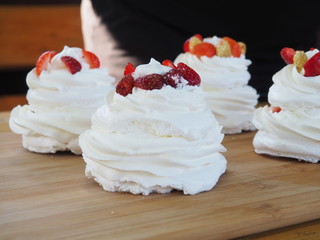 the chef decorates the dessert with fresh raspberries and strawberries. Anna Pavlovna's dessert