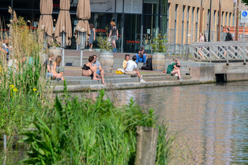 Enjoying The Sun At Oranje-Vrijstaatkade Canal At Amsterdam The Netherlands 9 May 2020