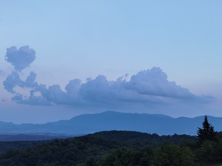A heart-shaped cloud over the mountain