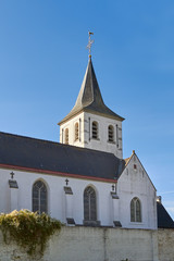 Fototapeta na wymiar Tower of white country village church in Flanders Belgium Sint-Martens-Latem