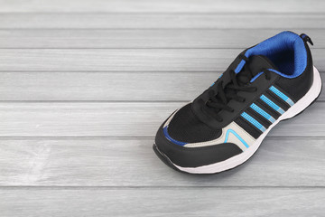 Indian made men's Sports Shoes on wooden table