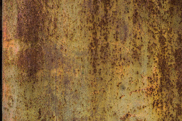 The old iron background is painted yellow, orange, purple, red in with rust and chips