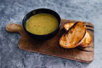 plant-based food, vegan pesto and zucchini soup with toasted bread