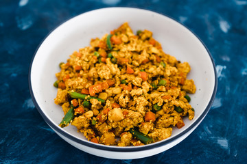 plant-based food, vegan tofu scramble with mixed vegetables including carrots green beans and peas