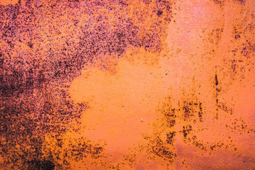 The old iron background is painted yellow, orange, purple, red in with rust and chips