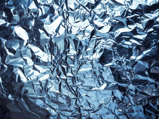 Abstract texture pattern metallic paper using as a background or wallpaper. Metal aluminum foil shiny and reflector