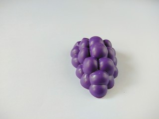 Grape fruit toy made from plastic on white background, usually used by children to play