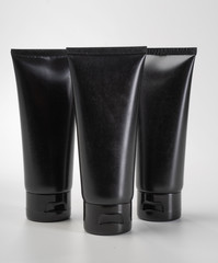 Tube pouch standing black plastic product mockup. over white background