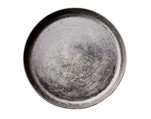 Old black cast iron Frying pan isolated on white background top view close-up