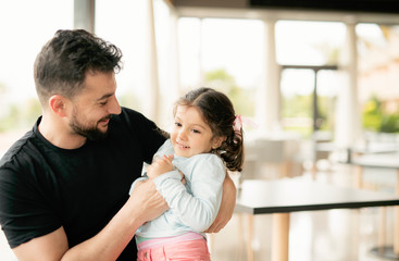 Father playing with daughter in modern site