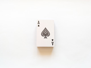 Fototapeta na wymiar Top view of a deck of playing cards with an ace with a spade suit on top isolated on a white background. The concept of games, gambling, fun, win, loss, free time.
