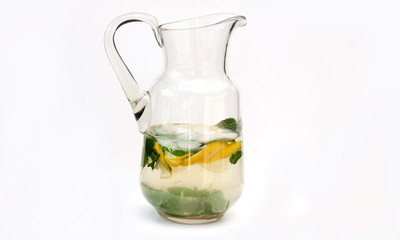 
A jar of homemade lemonade (mojito) isolated on a white background. Detox drink water with lemon and mint