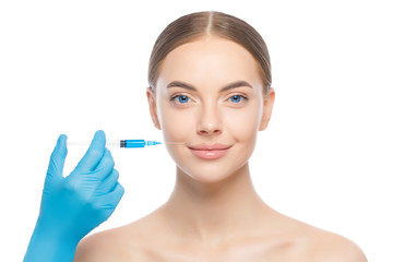 Young woman standing with naked neck and shoulders ready to be injected by beautician, isolated on...