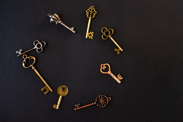 Many different old keys from different locks, scattered chaotically, flat lay.