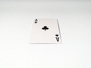 A close up view at one ace card with a club suit from a deck of playing cards. The concept of games, gambling, fun and free time.