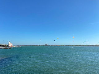 People practicing kitesurf. Kitesurfers on the mouth of the Cavado River in Esposende, Portugal. Esposende it's renowned by kite-surfers as one of the best places to kitesurf.