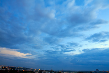 Blue Hour Over the City . Cumulus Clouds Early in the Morning 