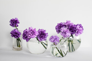 Bridal bouquet of lilac carnations in a round glass vase