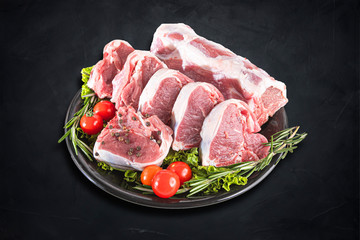 Fresh and raw meat. Whole piece of red meat ready to cook on the grill or BBQ . Background black blackboard