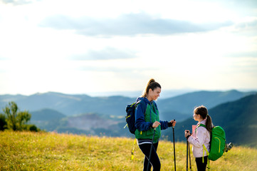 Fototapeta na wymiar Young single mother hiking together with her daughter