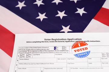 American citizens fill out the form to apply in the voting, on patriotic background of American flag.