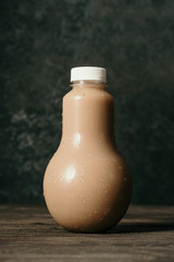 fresh coffee drink on a plastic bottle over dark background