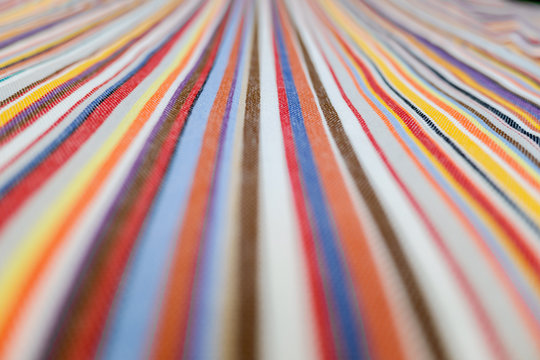 background of parallel colored lines on a fabric.