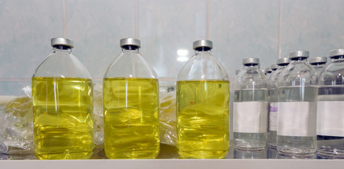 Saline bottles on the medical table in intensive care.