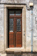 Fototapeta na wymiar Fine Wooden Doors Along Alley, Caminha, Portugal